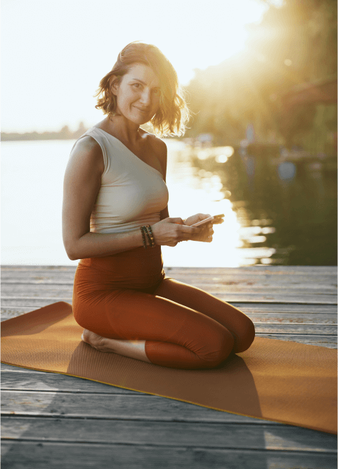 Woman smiling on a yoga mat